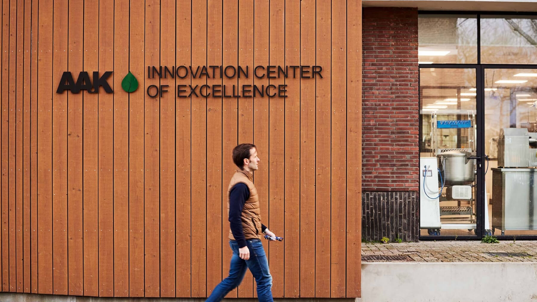 Man walking in front of the AAK innovation center of excellence building
