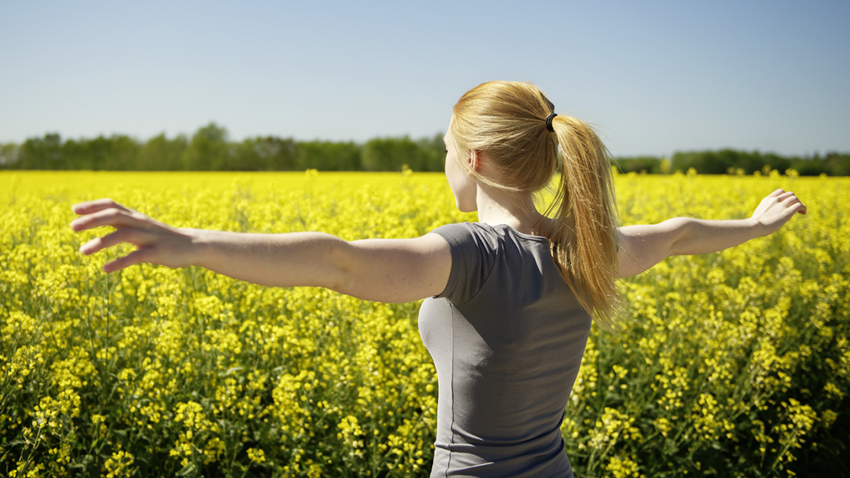 Woman standing in front of rapeseed field - Special Nutrition - AAK