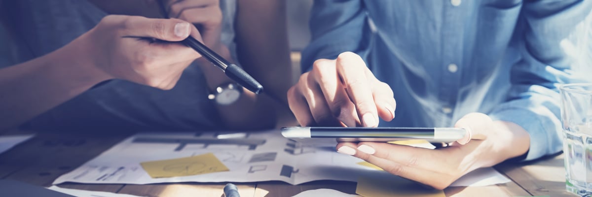 Two Female Co-Workers with Tablet and Financial Documents - Investors - AAK