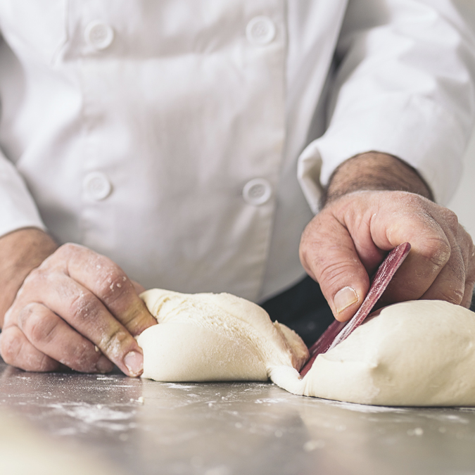 Baker Dividing Bread Dough Into Pieces - Bakery - AAK