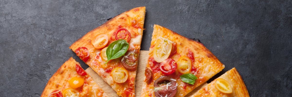 Delicious Pizza with Basil and Tomato on a Marble Table - Bakery - AAK