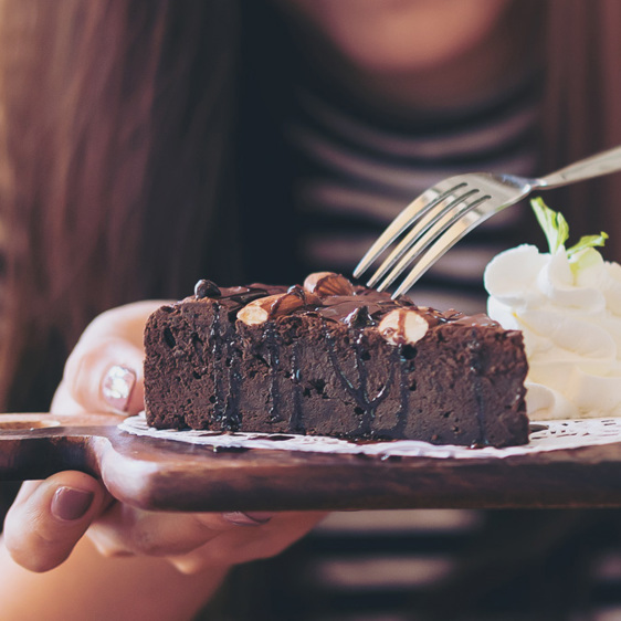 Chocolate cake and whipped cream on a plate - Applications - AAK