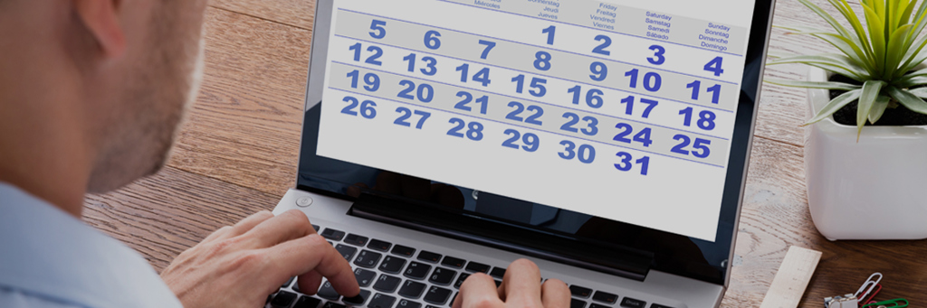Man typing on laptop keyboard and looking at calendar - Investors - AAK