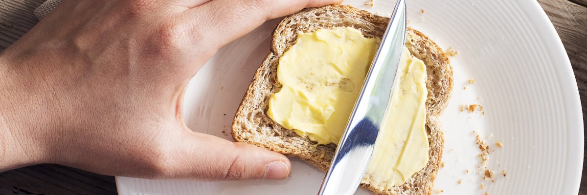 Buttering a slice of bread - Dairy and Ice cream - AAK