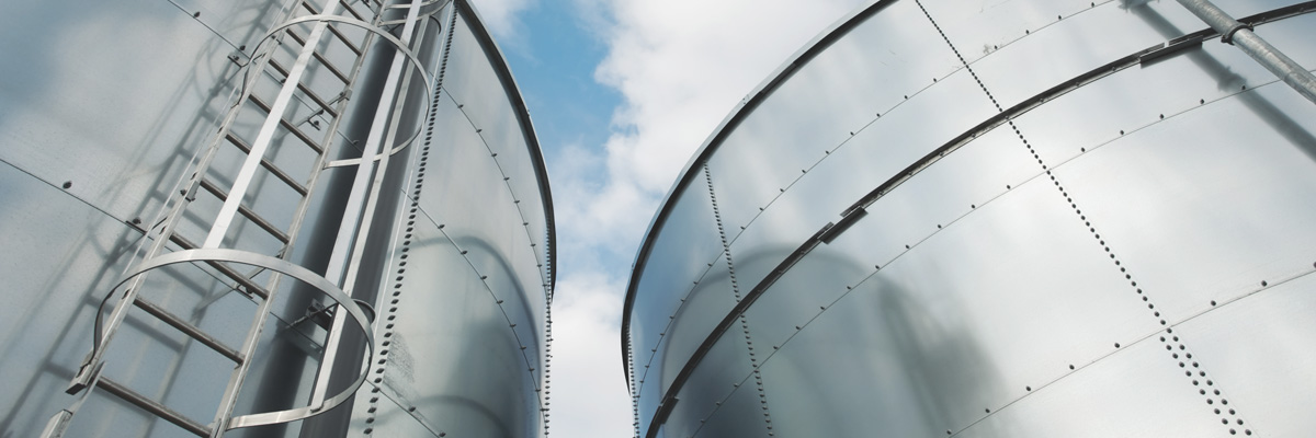 Low-Angle Shot of Ladder and Tanks Refinery - About Us - AAK