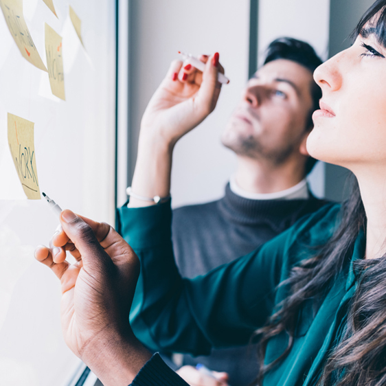 Business People in Front of Glass Wall with Post-It Notes - Careers - AAK