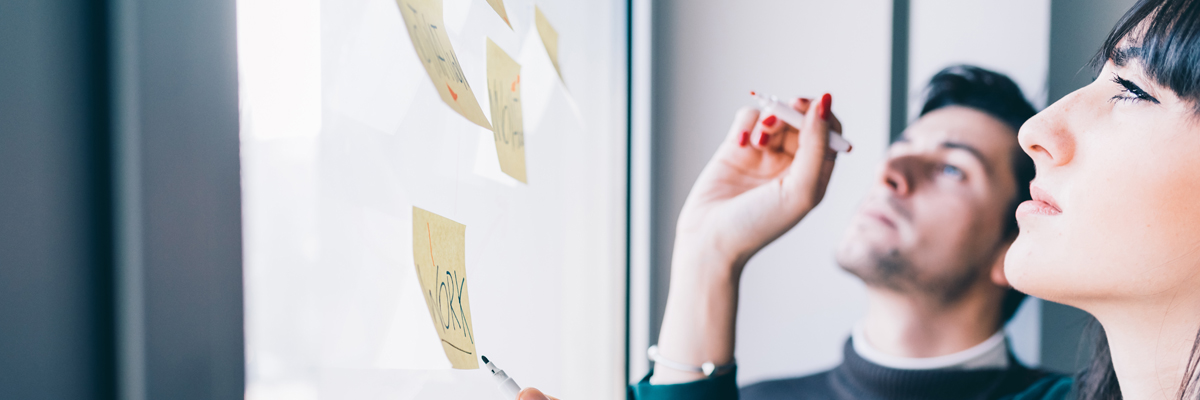 Business People in Front of Glass Wall with Post-It Notes - Careers - AAK